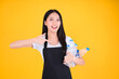 © Png - Video - Photo - attractive asian female smile wearing  apron pointing fingers to plastic bottle in a garbage bag for Recycling, world environment day.
