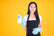 © Png - Video - Photo - attractive asian female smile wearing black apron her hands with blue rubber gloves holding a white spray bottle poses cleaning.