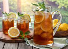 Pitcher Of Cold Ice Tea With Rural Summer Background
