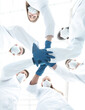 © ASDF - Doctors and nurses in a medical team stacking hands