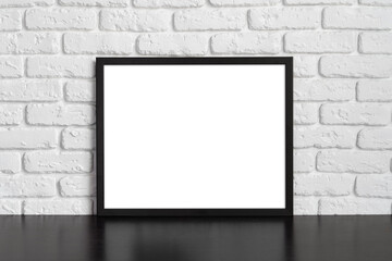 Wall Mural - Blank picture frame against brick wall with copy space