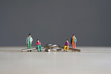 Fototapeta Most - Miniature figurine character: two people sitting on Yin and Yang puzzle, two people standing on wooden floor for playing game competition, selected focus