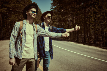 Canvas Print - hitchhikers catching a car