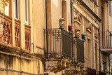 Fototapeta  - Traditional Sicilian human ceramic Moorish heads on a decorated balcony of urban house in Taormina town, island Sicily, Italy, Europe, EU. Walking in old Mediterranean street in Italy