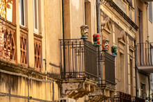 Traditional Sicilian Human Ceramic Moorish Heads On A Decorated Balcony Of Urban House In Taormina Town, Island Sicily, Italy, Europe, EU. Walking In Old Mediterranean Street In Italy