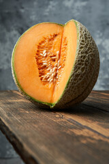 Wall Mural - Close-up of cut melon on a wooden table. Grey background. Best fruit in summer. Fruit. Healthy food concept. Front-view