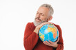 © InsideCreativeHouse - Cheerful caucasian mature middle-aged man holding embracing hugging globe Earth for environment nature protection isolated in white background
