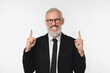 © InsideCreativeHouse - European mature middle-aged businessman ceo boss freelancer lawyer teacher pointing upwards at copyspace showing free space for ads isolated in white background