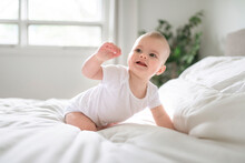 Adorable Baby Boy In White Sunny Bedroom In The Morning At Home
