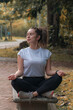 © elking - healthy lifestyle woman meditating , relaxing outdoors in a nature park , practicing yoga