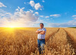 © Ryzhkov Oleksandr - farmer standing in a wheat field