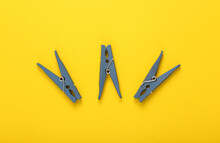 Plastic Clothespins On Yellow Background. Top View