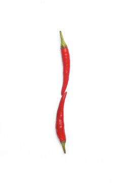 Letter I made from red chilli peppers isolated on white background
