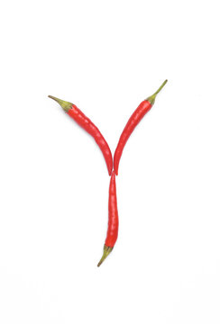 Letter Y made from red chilli peppers isolated on white background