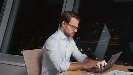 Poster - Young caucasian man professional using computer sitting at the desk in workplace