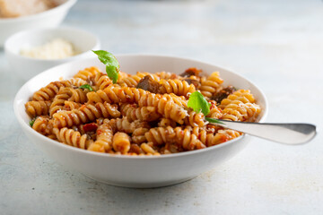 Wall Mural - Pasta alla Norma - traditional Italian food with eggplant, tomato, cheese and basil