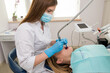 © Tania - Dentist-hygienist conducts a teeth cleaning procedure for a girl in a dental clinic. Removal of tartar.