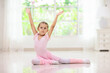 © famveldman - Baby ballet. Little ballerina girl in dance class.