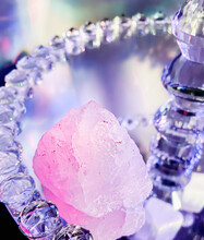 Pure Rose Quartz Displayed On A Decorative Mirrored Glass Staand