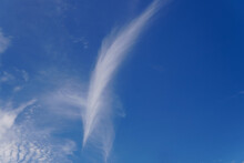 White Feather On Sky, Fluffy White Clouds Shaped Like A Feather, A White Swan Wing-shaped Cloud In The Blue Sky.