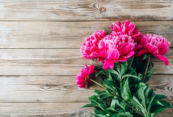 Pink peonies on a rustic wooden background