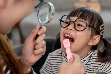 mom checks daughters baby teeth. Teeth grow in two rows. childrens medicine dentistry concept.