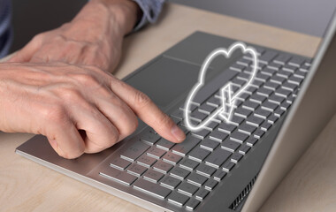 Poster - Cloud computing. Man using laptop for retrieving files from online storage. Forefinger closeup pressing on enter button. High quality photo