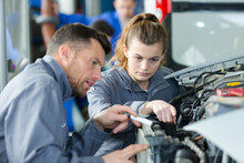 Woman As A Mechanic Apprentice In Auto Repair Shop