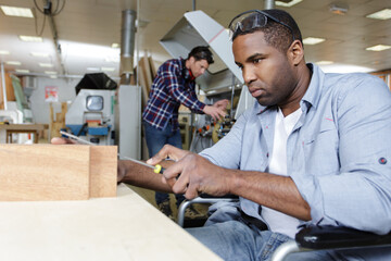 Wall Mural - disabled worker in wheelchair in a carpenters workshop