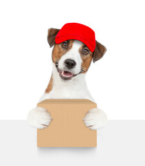 Poster - Jack russell terrier puppy wearing red cap holds big box above empty white banner. isolated on white background