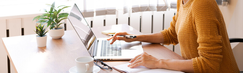 Cropped image professional business woman working in her office via laptop, young female manager using laptop computer device while sitting in Modern Loft, Flare Light, Concept Process Concept