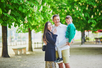 Wall Mural - Happy family of three enjoying their trip to Paris, France