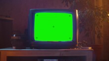 Close Up Footage Of A Dated TV Set With Green Screen Mock Up Chroma Key Template Display. Nostalgic Retro Nineties Technology Concept.