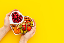 Hands Holding Heart Shaped Dish Full Of Healthy Diet Food