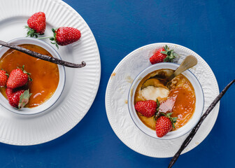 strawberries and cream caramel summer dessert  on blue background