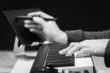 close up black and white male songwriter hands writing a hit song with midi keyboard. songwriting concept