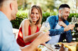 © djile - Group of young people enjoy lunch at a restaurant and drink wine