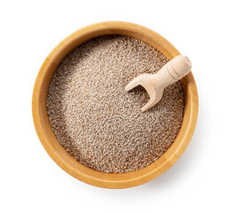 Wall Mural - White chia seeds and scoop in wooden bowl placed on white background.