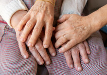 Hands Of The Elderly Person With Daughter