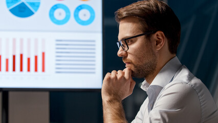 Poster - Thinking young businessman at work in office