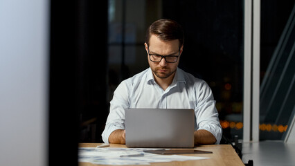 Poster - Young ceo typing message on laptop keyboard in office