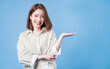 © Timeimage - Image of young Asian girl posing on blue background