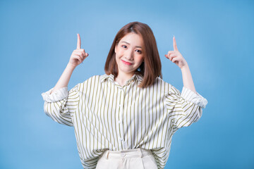 Image of young Asian girl posing on blue background