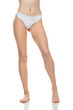 © vladimirfloyd - Front view of female barefoot legs in white bikini panties on a white studio background