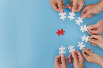 Wall Mural - Group of business people assemble jigsaw puzzles on blue background,  teamwork, help and support in business, symbol of association and connection. business strategy.