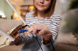 © DragonImages - Closeup image of woman plugging Ethernet cord in back of modem to get faster speed