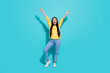 © deagreez - Full length photo of excited funny woman wear yellow pullover rising arms isolated teal color background