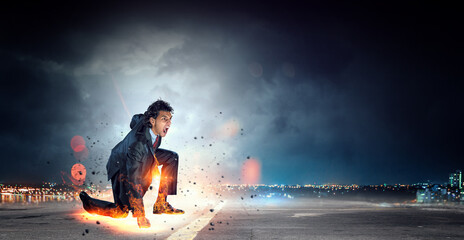 Wall Mural - Determined businessman leaving fire trails on asphalt