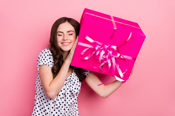 Wall Mural - Photo of dreamy pretty lady dressed dotted dress rising big present box closed eyes isolated pink color background