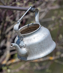 Old metal teapot in nature.